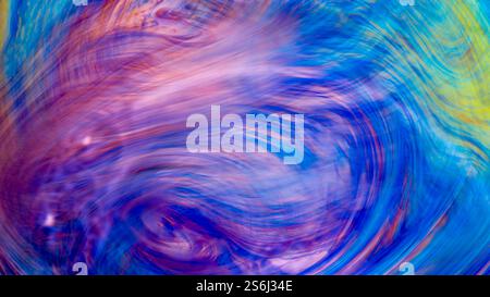 An abstract swirling colour of pink, green, blue & purple. Artistic and eclectic expressionism. Perfect as a piece of background or boheman wall art. Stock Photo