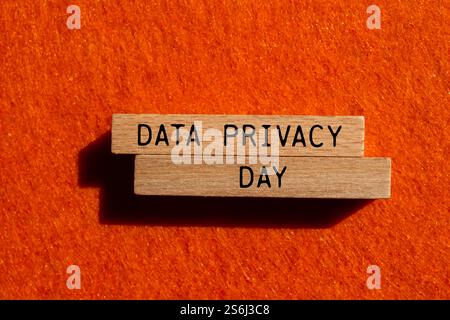 Data privacy day message written on wooden blocks with orange background. Conceptual data privacy day symbol. Copy space. Stock Photo