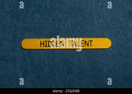 Hidden talent message written on yellow wooden stick with gray background. Conceptual hidden talent symbol. Copy space. Stock Photo