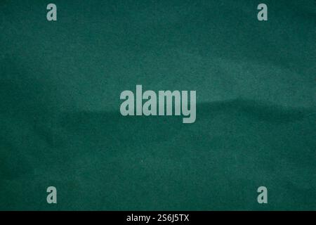 Abstract crumpled dark green paper background creased texture Stock Photo