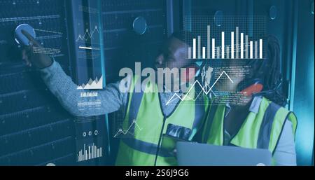 Image of diagrams and data processing over biracial workers in server room Stock Photo