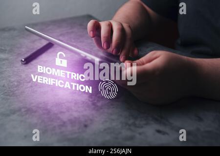 Biometric authentication concept. Digital tablet with fingerprint scanning. Access password thru fingerprints. Technology security system. Stock Photo