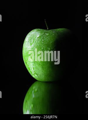 Wet droplets on green granny smith apple with black background. High quality photo Stock Photo