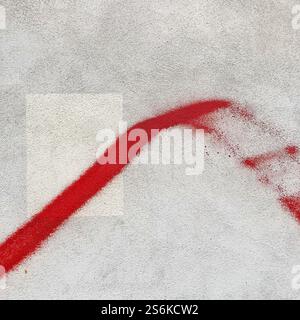 Artistic image showcasing a bold red brushstroke across a textured gray concrete surface, emphasizing minimalism and abstraction. Stock Photo