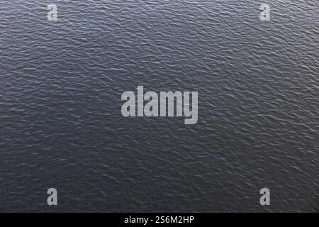 Dark blue water surface of vltava river flowing in prague Stock Photo