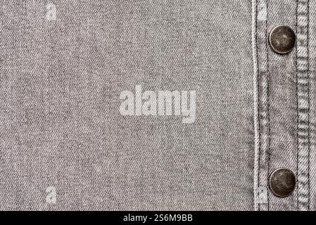 Macro background photography of denim fabric, grey jeans cloth, buttons and seam, fashion, design, textured frame, blank photo Stock Photo
