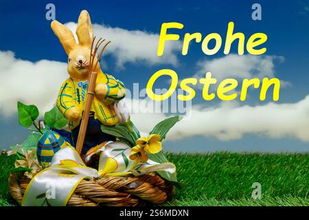 Easter greetings: Easter bunny with colourful Easter eggs with text FROHE OSTERN (Composing) Stock Photo