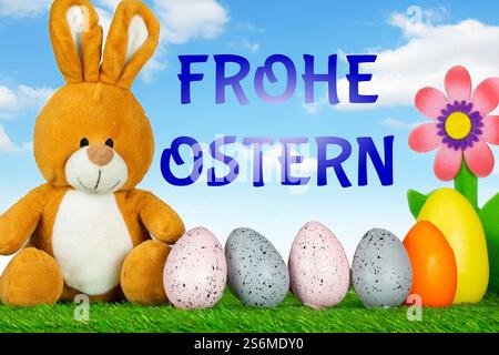 Easter greetings: Easter bunny with colourful Easter eggs with text FROHE OSTERN (Composing) Stock Photo