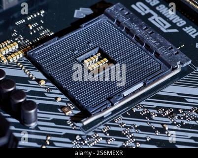A close-up view of an AM4 CPU socket on a motherboard. This detailed image shows the precision of the socket pins and the structure, perfect for hardw Stock Photo