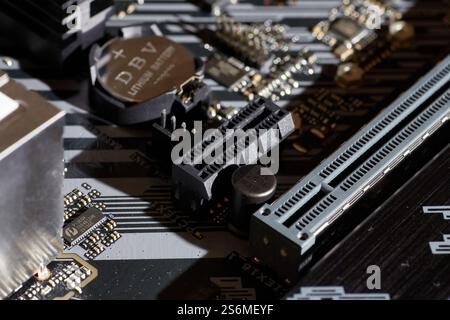 A detailed image of a motherboard showing PCIe slots, capacitors, and various electronic components. Ideal for use in technology-related projects, bac Stock Photo