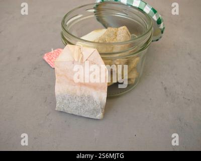 Used dried tea bags in a jar for homemade plant fertilizer for houseplants Stock Photo