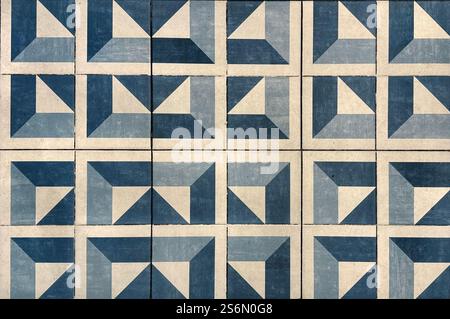 Abstract blue triangular cube geometric pattern painted on floor tiles. Blue modern mid century geometric pattern seamless background texture. Stock Photo