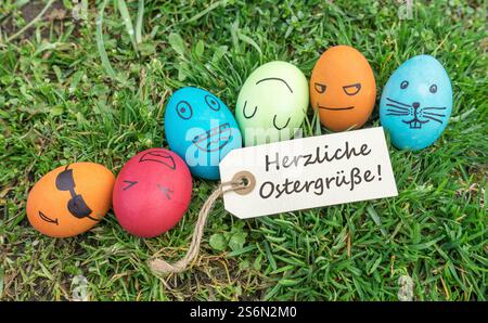 Easter eggs and greeting card with German text: Warm Easter greetings Stock Photo