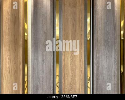 Series of curved moulded wood panel texture with golden tinted mirrors. Different wood tone color, warm wood and pale grey wooden veneer panel, with g Stock Photo