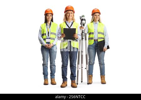 Group of female engineers with a surveying instrument isolated on white background Stock Photo