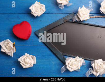 Red heart shaped gift box with a blackboard arrow on a wooden floor Stock Photo