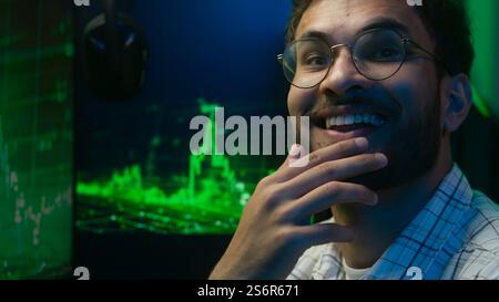Thoughtful pensive Arabian Indian man thinking pondering solution programmer coder hacker worker cyberspace analysis male guy puzzled trader broker Stock Photo