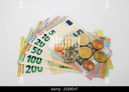 Various euro bills, 5, 10, 20, 50, 100 and 200 euro bills, arranged in a fan shape, euro coins, white background, Stock Photo