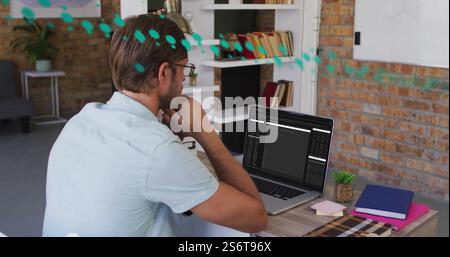 Image of data processing over caucasian businessman using laptop Stock Photo