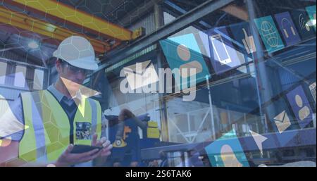 Using smartphone, construction worker with hard hat over digital icons image Stock Photo