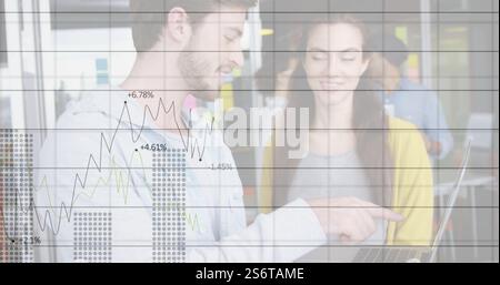 Business data chart image over colleagues discussing work on laptop Stock Photo