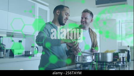 Cooking together in kitchen, green data processing image over couple Stock Photo