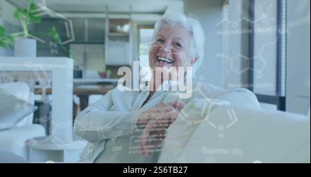Chemical formulas and molecular structures image over elderly woman relaxing on couch Stock Photo