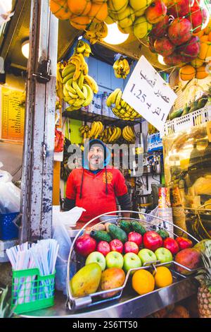 Jordan, Middle East, Amman. Al Balad district, fruit vendor, posing behind his stall Stock Photo