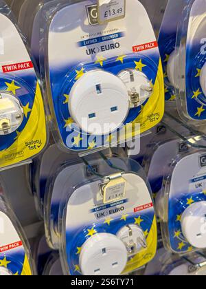 Adapter plug, between European and UK plugs Stock Photo