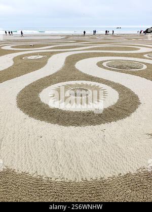People walking a Circles in the Sand labyrinth at Face Rock Beach in ...