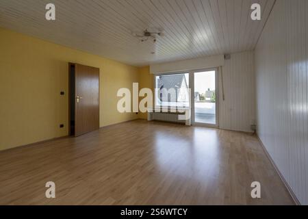 Renovated room in an old building without furniture, white ceiling panels and wall panels, floor with laminate, North Rhine-Westphalia, Germany, Europ Stock Photo