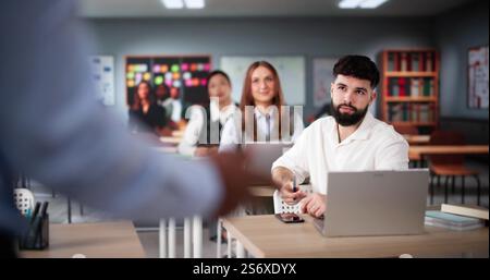 Teacher In Classroom Lesson. High school Education Stock Photo