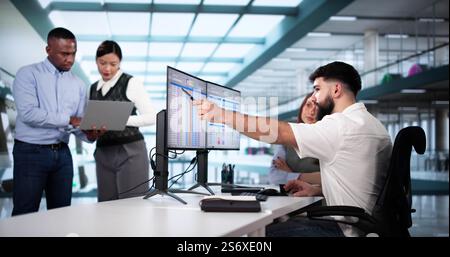 People Working With Spreadsheet Data On Computer Monitor Stock Photo