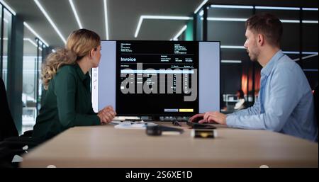 Accountant Checking Invoice For Online Payment On Computer Stock Photo