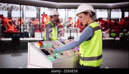 Worker In Automotive Car Factory Using Control Panel Stock Photo