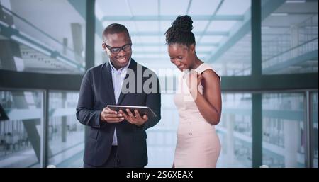 Businesspeople Discussing Standing Inside Elevator At Work Stock Photo