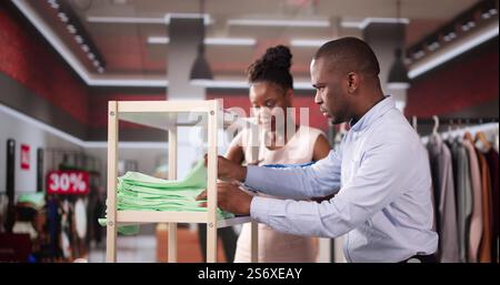 Couple Buying Fashion At Retail Clothing Store Stock Photo