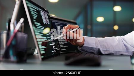 Programmer Or Coder At Office Desk Using Laptop Stock Photo