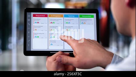 Scrum Project Manager Using Scrum Board Scheduling Software Stock Photo