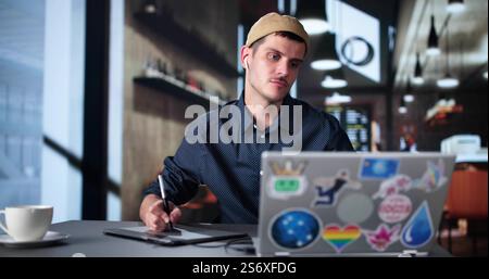 Graphic Photo Designer Using Computer Screen And Tablet Stock Photo