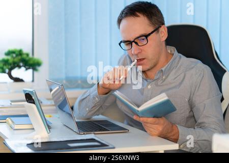 Businessman taking notes on notebook at office. The concept of business planning is conceived Stock Photo