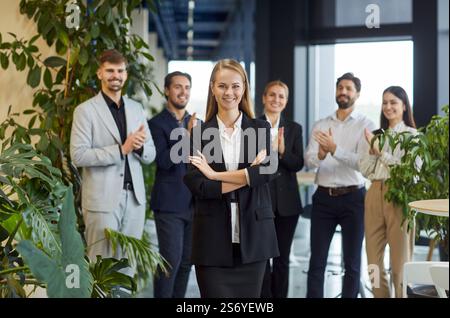 Happy Businesswoman With Team In Office Stock Photo