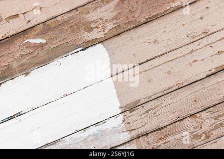 Old wooden wall with white and pink painted parts, abstract background photo texture, front view Stock Photo