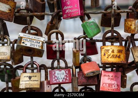 View of different coloured love locks on a bridge railing with names and dates, near Husum in autumn 2021 Stock Photo