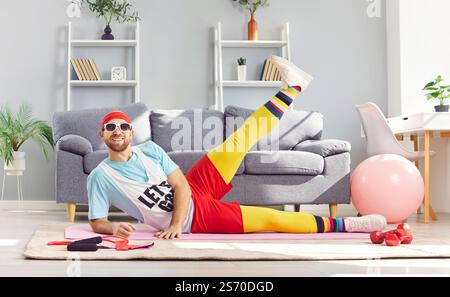 Funny man in bright sportswear doing sports at home Stock Photo