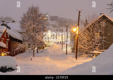 snowy-street-of-troms-norway-during-the-polar-night-people-walking