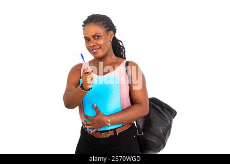 young female student wearing black backpack and holding document and showing pen while smiling. Stock Photo