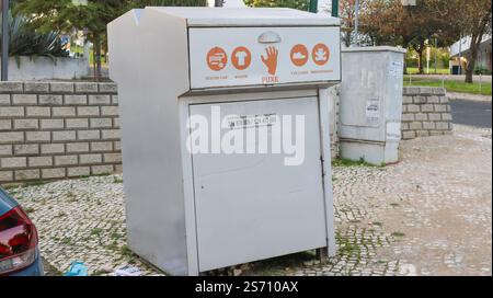 Metal container for donating clothes, shoes, and toys, encouraging recycling and supporting circular economy initiatives Stock Photo