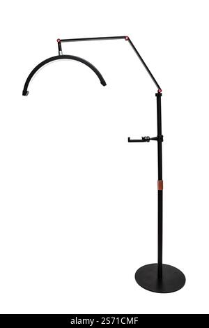 A sleek black floor lamp with an adjustable arm and curved LED light, perfect for modern interiors. Stock Photo