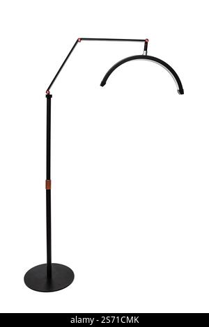 A sleek black floor lamp with an adjustable arm and curved LED light, perfect for modern interiors. Stock Photo